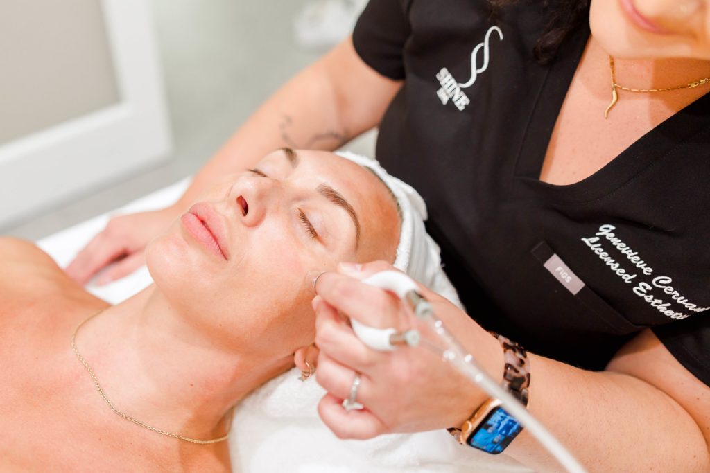 Esthetician Giving Facial Treatment to Patient | The Shine Spa in Clayton, MO